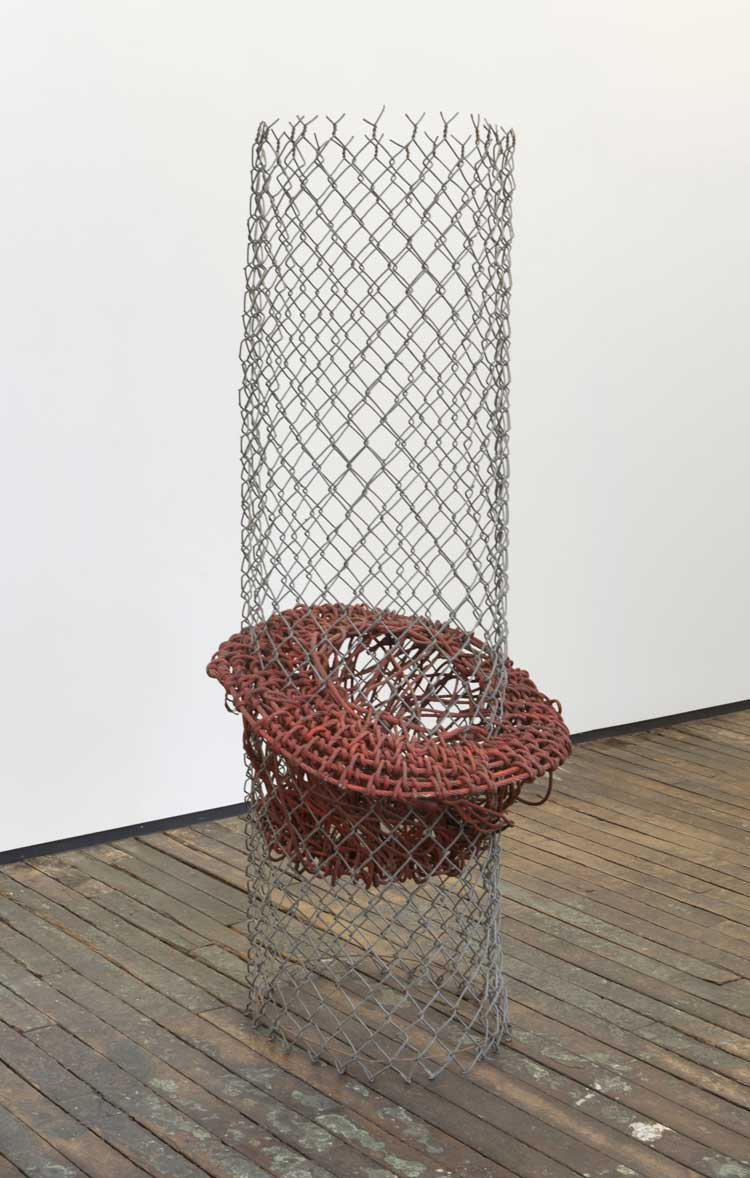 Alice Adams, 22 Tangle, 1964-8,
incorporating Fluorescent Structure of 1964. Rusted steel cable, fluorescent paint and aluminium, chain-link fence, 175.3 × 68.8 cm. Zürcher Gallery, New York. Courtesy of the artist and Zürcher Gallery, New York / Paris. Photo: Adam Reich.
