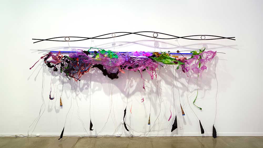 Judy Pfaff, Ram’s Delhi, 2012. Wood, mild steel rod, melted plastics, black aluminum foil, and LED and UV Fluorescent light, 70 x 132 x 17 in. Collection of the artist, New York.