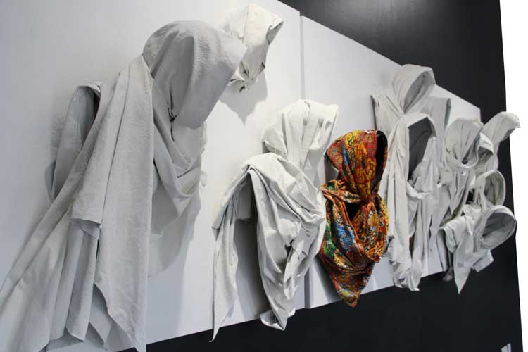 Péju Alatise. Orange Scarf goes to Heaven, 2012 (triptych). Nigerian cloth fixed and draped in a resin and mounted on canvas and acrylic. Photo © Péju Alatise.