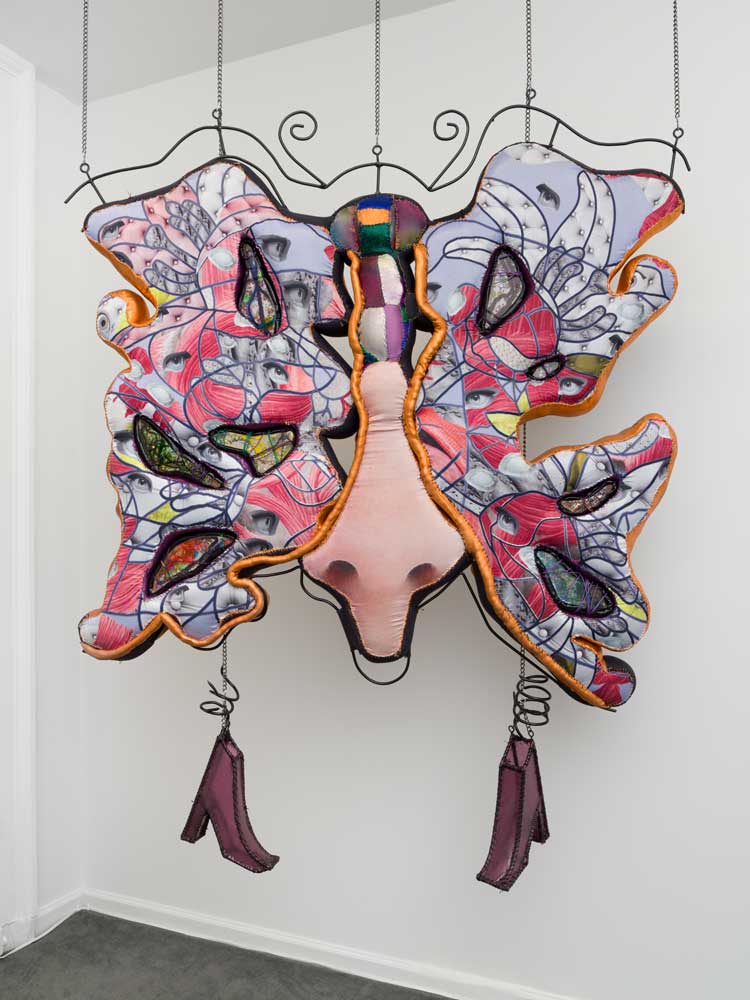 Florencia Escudero. Talisman, 2021. Hand-sewn digitally printed satin, spandex, and hand-marbled digitally printed fabric, hand-sewn spandex over cotton piping, foam, resin cast with metal earrings, rings, fake pearls, charms, ceramic beads, confetti, plastic crystals, false dread locks and braids, wrapped in wires and hand-sewn vinyl over piping, with hand-sewn crocodile-stamped vinyl, metal, and handbag chains, 87 x 54 x 7 in. Collection of Selig D. Sacks. Photo: Charles Benton. Photo courtesy of the artist and Kristen Lorello, New York.