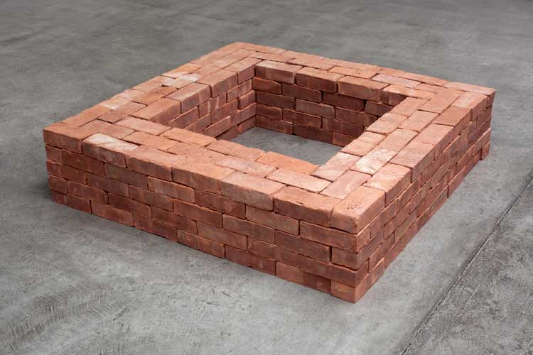 Jackie Winsor. Brick Square, 1971. 300 stacked bricks, 15 x 50 x 50 in. Courtesy of the artist and Paula Cooper Gallery, New York. © Jackie Winsor.