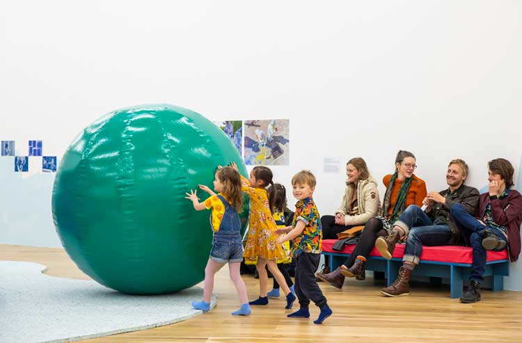 Inflatable green ball from The Fun House goes rolling again. Assemble and Schools of Tomorrow: The Place We Imagine, installation view at Nottingham Contemporary, 2022. Courtesy Nottingham Contemporary. Photo: Julian Hughes.