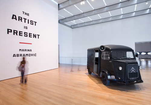 Marina Abramović. Entrance to the exhibition Marina Abramović: The Artist is Present, The Museum of Modern Art, New York, 2010. Photo by Jason Mandella. In this photo: Marina Abramović and Ulay, Relation in Movement, 1977. Video (black and white, silent), sound environment (2010), Citro