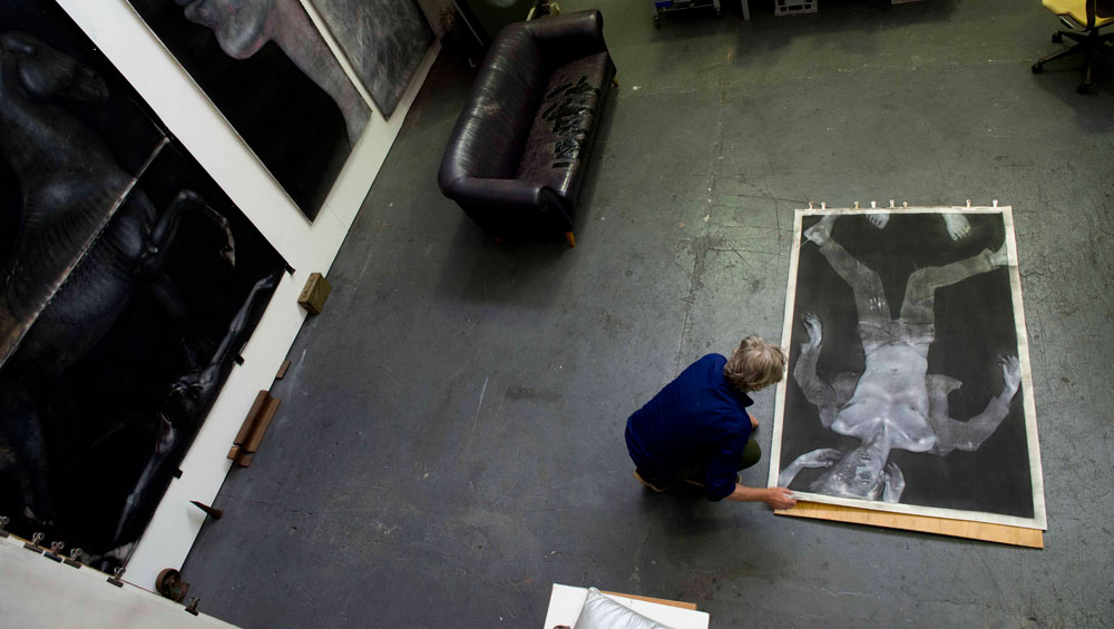 Studio photograph of the artist with Profile in Exile Version 2, 2003. Chinagraph, silver oxide and pastel. Collection of the artist. Photograph: Julian Di Stefano.