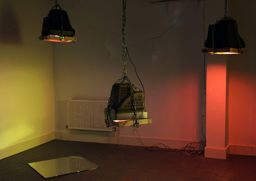 Toby Ross-Southall. Being Silent Isn't Strong (Installation View), 2010. DVD loop, chain, wood, TVs, mirror, dimensions variable. © the artist.