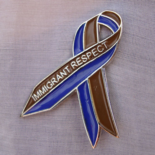 Tania Bruguera. Awareness Ribbon for Immigrant Respect Campaign, 2011. Awareness campaign. Metal pins, community meetings, letters sent to elected officials, media. Photograph: Camilo Godoy Courtesy of Immigrant Movement International (web).