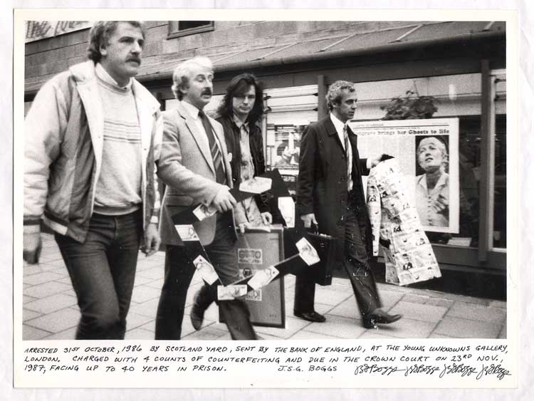 Artist J.S.G Boggs being led away by Scotland Yard detectives from The Young Unkowns Gallery charged with 4 counts of counterfeiting, middle detective carrying seized Grey Organisation art work, press photograph, London, 1986.