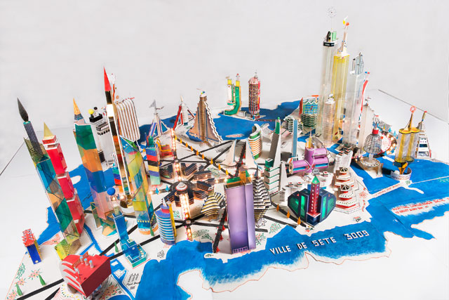 Bodys Isek Kingelez. Ville de Sète 3009, 2000. Paper, paperboard, plastic, and other various materials, 31 1/2in × 9ft 10 1⁄8in × 6ft 10 11⁄16in (80 × 300 × 210 cm). Collection Musée International des Arts Modestes (MIAM), Sète, France. © Pierre Schwartz ADAGP; courtesy Musée International des Arts Modestes (MIAM), Sète, France.