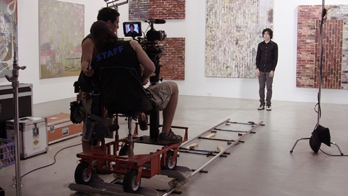 Xavier Cha. de la Cruz Shoot, 2011. Lights, dolly, track, DP, grip,actors. Film shoot as installation open to public view at the de la Cruz Collection. Lighting and tracks were set up to capture two familiar cinematic shots.