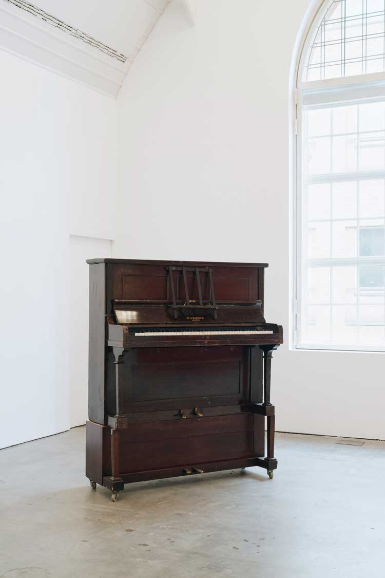 Angela de la Cruz, Upright Piano, 1999. Installation view, UPRIGHT, Ikon Gallery, Birmingham, 2026. Image courtesy Ikon. Photo: Tom Bird.