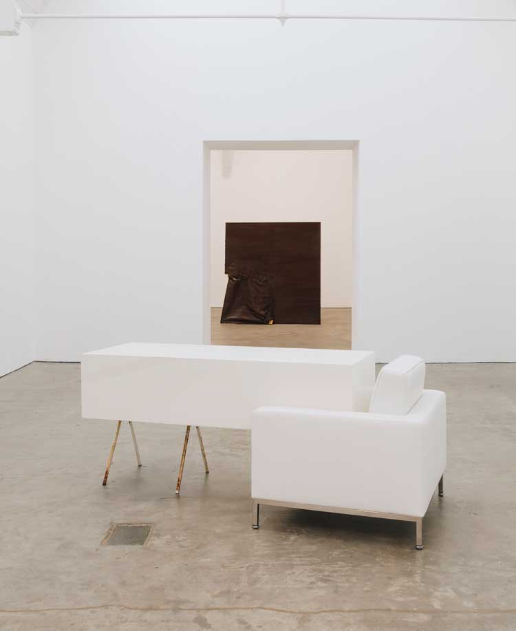 Angela de la Cruz, Transfer (White) with Armchair, 2011 (foreground). Installation view, UPRIGHT, Ikon Gallery, Birmingham, 2026. Image courtesy Ikon. Photo: Tom Bird.