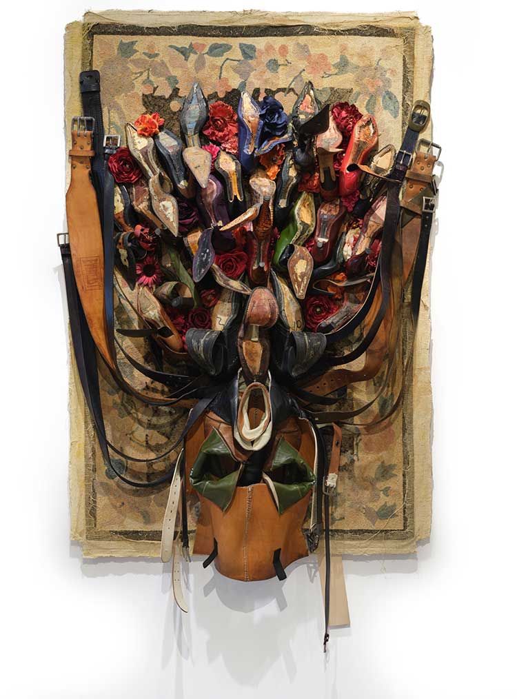 Anindita Dutta, Song Under the Carpet, 2025, carpet, used shoes, belts, artificial flowers, 80 × 49 × 12 in. Photo: Martin Seck