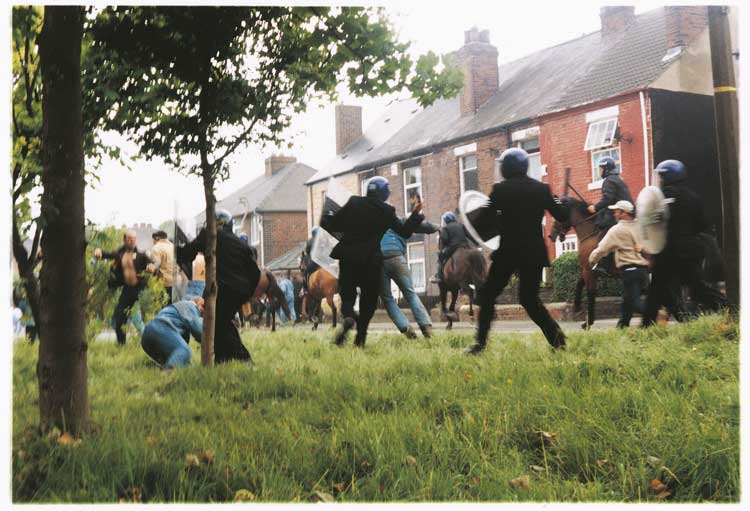 Jeremy Deller. The Battle of Orgreave, 2001. Police officers pursuing miners through the village. Courtesy of The Artist and The Modern Institute / Toby Webster Ltd., Glasgow. Photo: Parisah Taghizadeh.