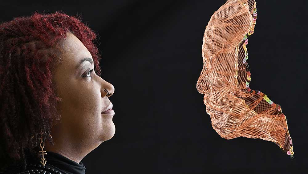 Curator Cat Dunn with Ashanti Harris' artwork Emi Ori Cse in Copper. Photo: Neil Hanna.