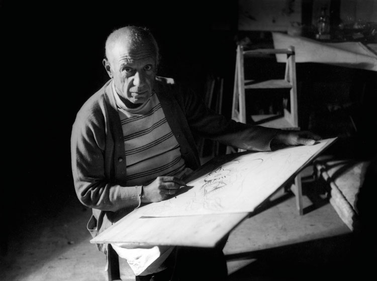 Pablo Picasso drawing in Antibes, summer 1946. Black-and-white photograph. Photo © Michel Sima / Bridgeman Images. © Succession Picasso/DACS 2019.