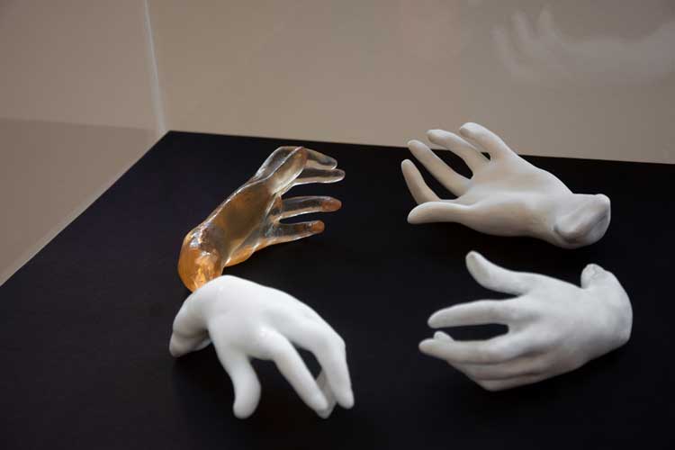 Rebecca Fortnum, Les Praticiennes (A Gesture to Genius), 2023, after Auguste Rodin (1840-1917), France. Study of a Hand (Le Main Gauche: Le Pianist), n.d., bronze. Ashmolean Museum, Oxford. Four versions in porcelain, resin, clear resin and plastic with acrylic paint, 12 x 7 cm each. 3D scanning by Scan The World. Printing by Glasgow School of Art. Casting by Martha Todd. Installation view, Henry Moore Institute, 2023. Courtesy the artist and the Henry Moore Institute.
