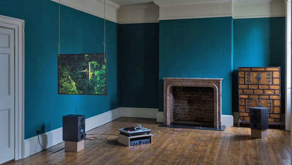 Louisa Fairclough. A Rose, 2017. 1 x 16mm film looped (colour, silent, 9 min) projected onto a suspended acrylic screen, 1 x performance for a field recording pressed onto dubplate vinyl (20 min). Installation view: A Song cycle for the Ruins of a Psychiatric Unit, Danielle Arnaud Gallery, 2017. Photograph: Oskar Proctor. Courtesy the artist and Danielle Arnaud.