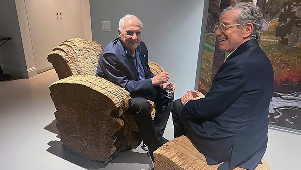Frank Gehry sitting in one of the Little Beaver cardboard armchairs he designed. Photo: Ann Philbin.