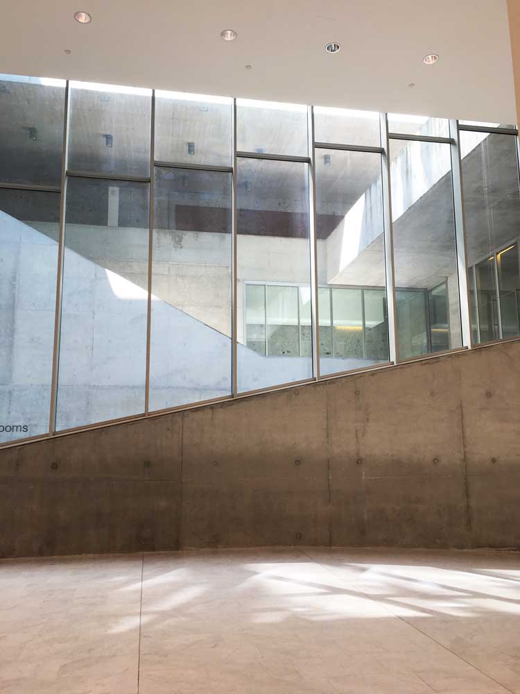 The Luigi Bocconi university building in Milan. Pale marble (Bianca Lasa) floors in the lower ground floor space capture light from the windows above. Photo: Veronica Simpson.