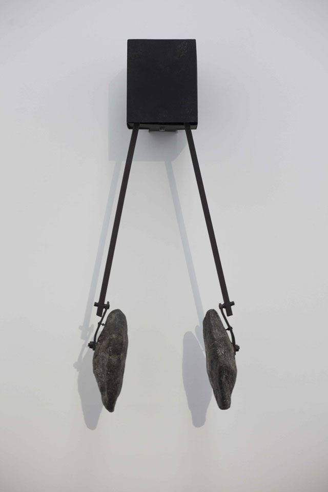 Shilpa Gupta. Song of the Ground, 2017. Mechanical installation, borderland river stones, 79 x 22 x 18 cm (31 x 8 x 13 in).