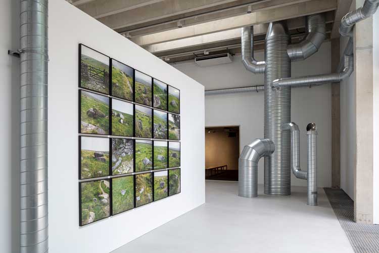 Nancy Holt, Trail Markers, 1969. 20 inkjet prints on archival rag paper. Ventilation Systems 1985-92 (detail), steel ducts, turbine ventilators, shanty caps, fans, air. Artwork © Holt/Smithson Foundation / Licensed by Artists Rights Society, New York. Photo: Lucy Dawkins / Courtesy Goodwood Art Foundation.