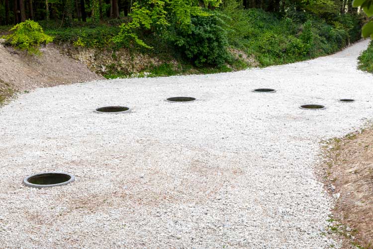 Nancy Holt, Hydra’s Head, 1974. Installation view, Goodwood Art Foundation, 2026. Concrete, earth, water. Photo: Maria Bell / Courtesy Goodwood Art Foundation. © Holt/Smithson Foundation / Licensed by Artists Rights Society, New York.