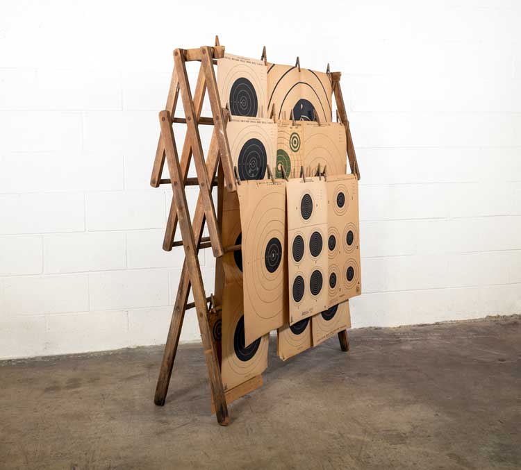 Lonnie Holley, Hung Out, 2021. Wooden drying rack, rifle targets, and clothes pins. Image courtesy of the artist and Edel Assanti. Photo: Truett Dietz.