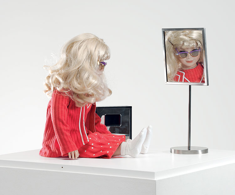 Lynn Hershman Leeson. CyberRoberta, 1996. Custom-made doll, clothing, glasses, webcam, surveillance camera, mirror, original programming, and telerobotic head-rotating system, approximately 17 ¾ x 17 ¾ x 7 ⅞ in (45 x 45 x 20 cm). Courtesy the artist; Bridget Donahue Gallery, New York; and Altman Siegel, San Francisco.