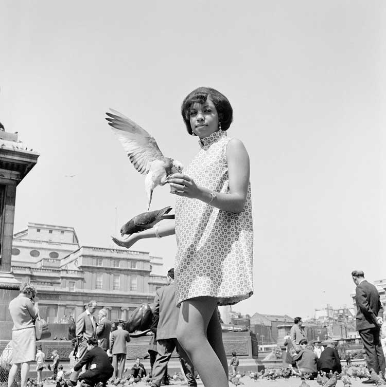 James Barnor. Erlin Ibreck at Trafalgar Square, 1966/67. Digital Fibre Print, 70 x 70 cm. Copyright James Barnor. Courtesy the Artist and October Gallery, London.