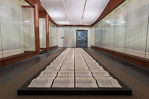 Xu Bing. Book of the Sky, c 1987–91. Installation of hand-printed books and ceiling and wall scrolls printed from wood letterpress type; ink on paper, each book, open: 18 1/8 × 20 in. (46 × 51 cm); three ceiling scrolls, each: 38 in. × approx. 114 ft. 9 7/8 in. (96.5 × 3500 cm); each wall scroll: 9 ft. 2 1/4 in. × 39 3/8 in. (280 × 100 cm). Lent by the artist. © Xu Bing.