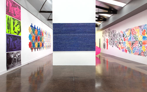 Irene Barberis. Installation view: Apocalypse/Revelation: Re Looking (Feminale; the edge of logic, intersecting luminosities).
Centre: Writings on the Wall (on canvas) #7, (Revelation Chapters 16 -22), 2012. Primed canvas, acrylic housepaint, white marker and chalk pen, 1.4 x 3 m.
Right: Cut it Out! Its a Wonderful World; Resurrection in Melbourne2012 (after Stanley Spencer), 2012. Laser cut acrylic with coloured mapping pins.
Photograph: Mark Ashkanasy.