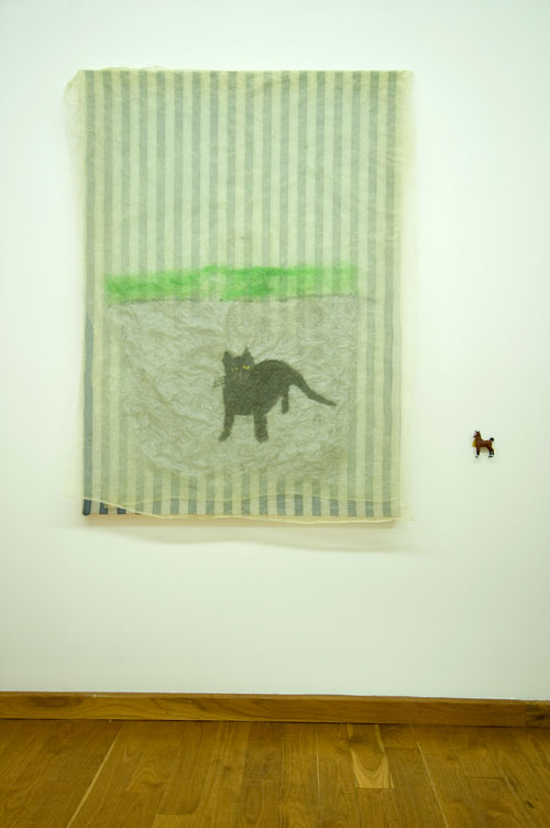 Jenny Watson. Cat 2007. Acrylic on rabbit skin glue primed cotton, stretched, with organza overlay + small plastic horse, 128 cm x 91 cm. Courtesy Transit Gallery, Mechelen, Belgium.
