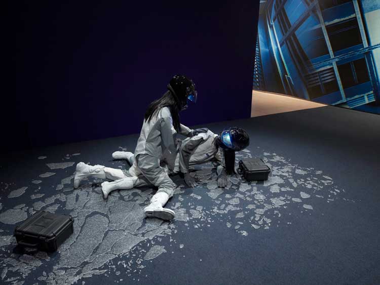 Ayoung Kim. Ghost Dancers B. 2022. Mannequins, costumes, helmets, LED masks, gloves, boots, reinforced cases, and tempered glass. Courtesy MoMA PS1. Photo: Roz Akin.
