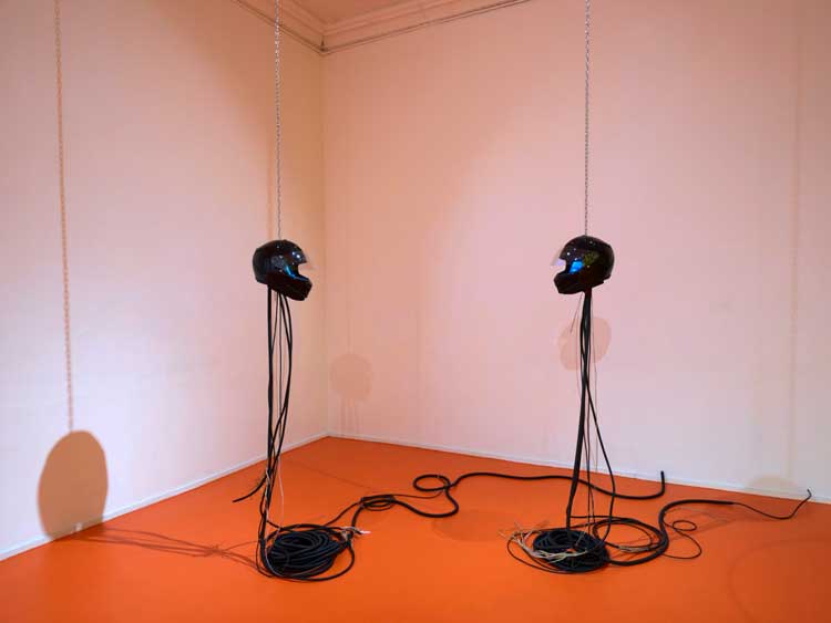 Ayoung Kim. Ghost Dancers A. 2022. Helmets, video, tablets, wire, corrugated tube, and metal chain. Courtesy MoMA PS1. Photo: Roz Akin.