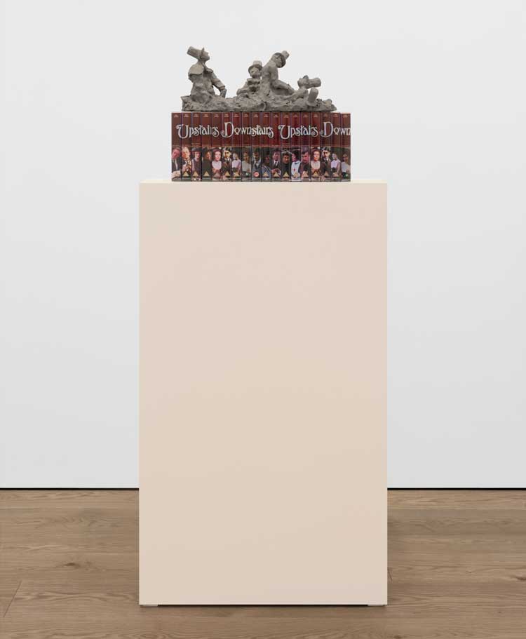 Nicole Wermers, A Gay Crime, 2025. Reinforced air dry clay, VHS tapes and covers, overall 41 x 54 x 23 cm (16 ⅛ x 21 ¼ x 9 in), clay sculpture: 20 x 48 x 23 cm (7 ⅞ x 18 ⅞ x 9 in), VHS tapes: 21 x 54 x 12 cm (8 ¼ x 21 ¼ x 4 ¾ in). © Nicole Wermers. Courtesy the Artist and Sadie Coles HQ, London. Photo: Katie Morrison.