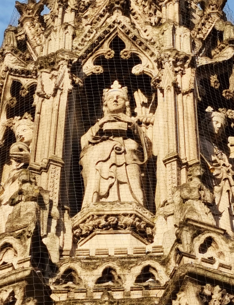 Eleanor of Castile, designed by Edward Middleton Barry, statue sculptor Thomas Earp. Statues in Portland stone, monument red sandstone, 1865, after an original of 1291–94. Outside Charing Cross Station, Strand. Photo: Juliet Rix.