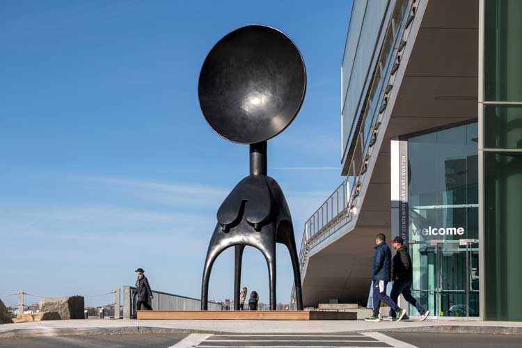Simone Leigh, Satellite, 2022. Bronze, 24 × 10 × 7 ft 7 in (7.3 × 3 × 2.3 m). Installation view, Simone Leigh, the Institute of Contemporary Art/Boston, 2023. Courtesy the artist and Matthew Marks Gallery. Photo: Timothy Schenck. © Simone Leigh.