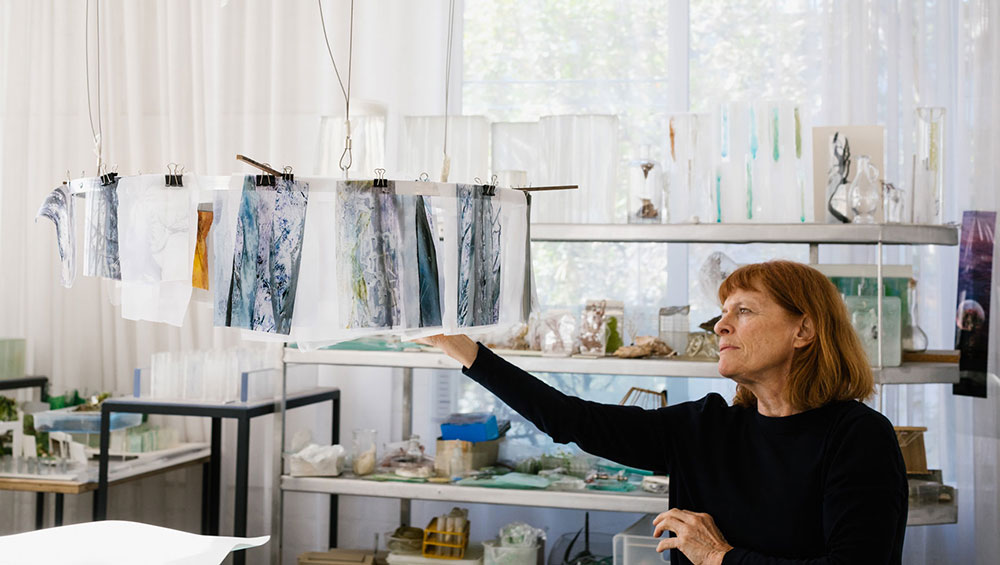 Janet Laurence with her work Solids by Weight, Liquids by Measure from the Periodic Table series, 1993.