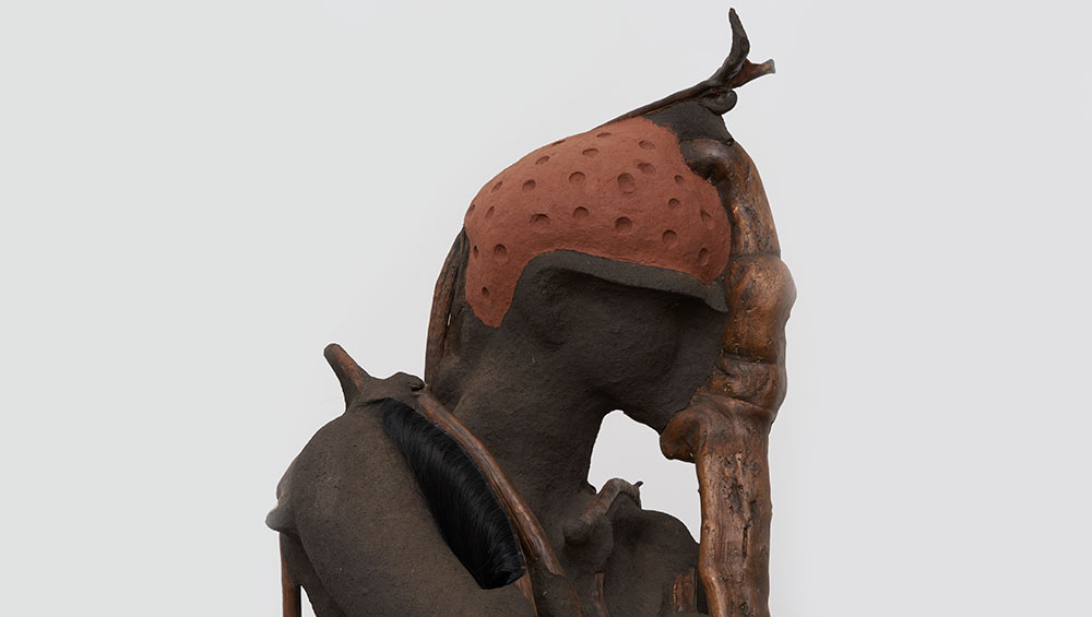 Wangechi Mutu, She Walks, 2019. Red soil, charcoal, paper pulp, wood, wood glue, steel nails and synthetic hair, 82 7/10 x 39 4/5 x 20 1/10 in. Photo: Courtesy of the Artist and Victoria Miro, London.