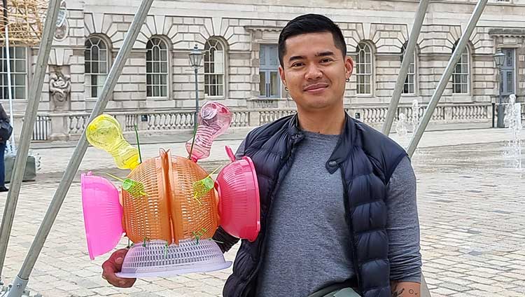 Leeroy New with junk space helmet with his installation The Arks of Gimokudan at Somerset House, London, 2022. Photo: Juliet Rix.