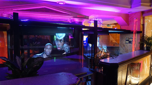 Funda Gül Özcan. It happened as expected, 2018, installation view. Multi-media video installation with sound, sculpture, painted uniforms, plastic flowers, light sources and posters. Work commissioned by Steirischer Herbst ’18. Photo: Funda Gül Özcan.