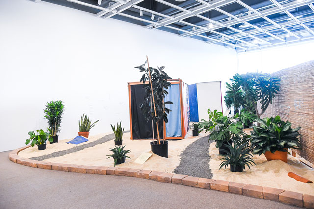 Hélio Oiticica. Installation view. Tropicália, 1966-67. Plants, sand, birds, poems by Roberta Camila Salgado on bricks, tiles and vinyl squares. Collection of César and Claudio Oiticica. Photograph by Matt Casarella
