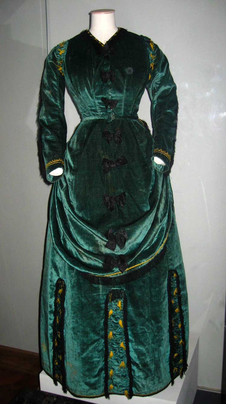 Unknown maker, The Green Dress, c1870. Silk bows and ribbon, metal hooks, metal eyes, lined with cream cotton. Watts Gallery Trust.