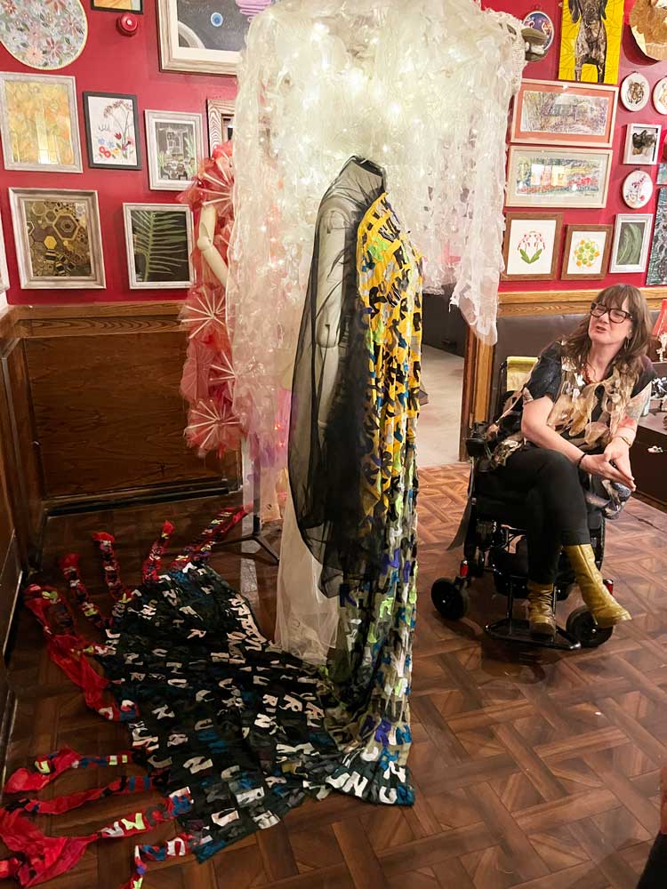 Artist Eleanor Roberts with art costumes inspired by everything from menopause to life with ME. Installation view, Come As You Really Are by Hetain Patel and Artangel, Grants, Croydon 2024. Photo: Veronica Simpson.