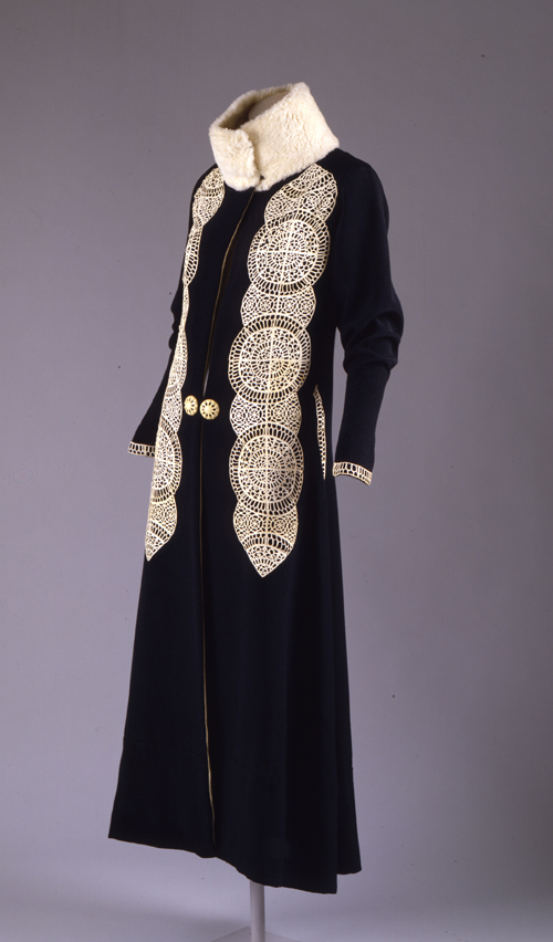 Paul Poiret (French, 1879–1944). Coat, ca. 1919. Black silk and wool rep weave with white kid cutwork appliqué and white broadtail trim. The Metropolitan Museum of Art, Gift of Mrs. David J. Colton, 1961