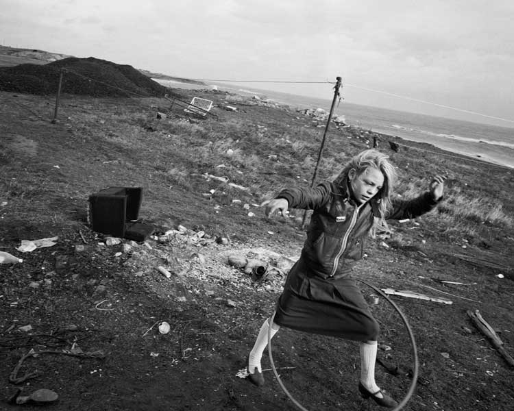 Chris Killip, Helen and her Hula-hoop, Seacoal Camp, Lynemouth, Northumberland,1984. © Chris Killip. Photography Trust / Magnum Photos, courtesy Martin Parr Foundation.