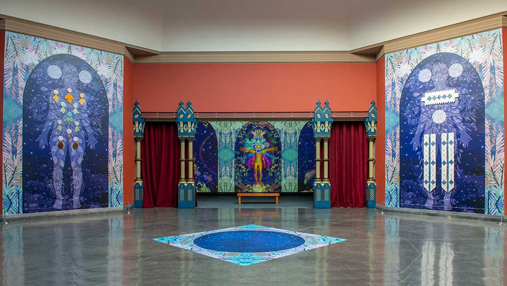 Saya Woolfalk. We Emerge at the Sunset of Your Ideology, 2022. (installation detail view). Multimedia installation, four figures: glass and digital collage vinyl mural, 214 x 145 inches each. 2 single-channel colour videos, infinite loop with sound. Pennsylvania Academy of the Fine Arts. Photo: Lori Waselchuk.