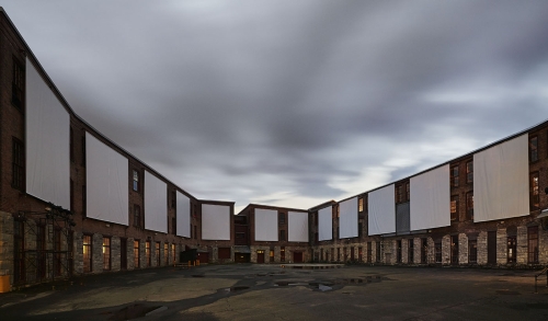 Clifford Ross. Daytime view of immersive Harmonium Mountain video screens. Courtyard D. MASS MoCA.