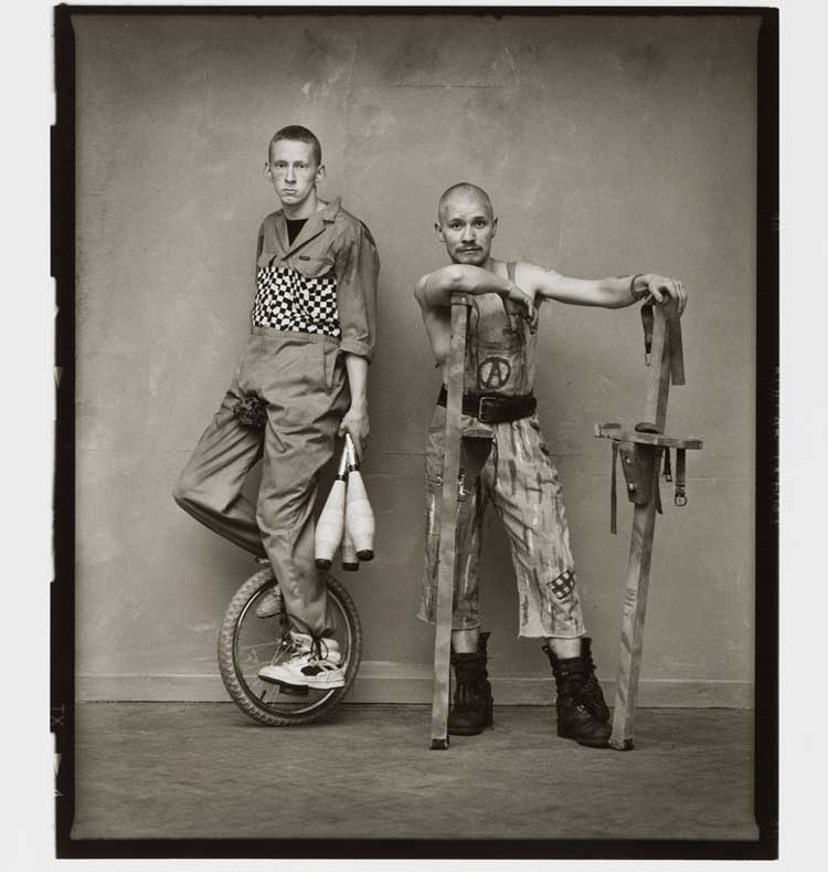 David Eustace, Man on monocycle, man with stilts. The Buskers Portfolio October 1993. © David Eustace