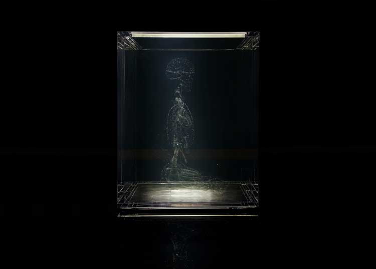 Tavares Strachan, Seated Panchen Lama, 2011. Pyrex figure, mineral oil, acrylic, 34.5 H x 34.5 L x 22.5 W in (87.63 H x 87.63 L x 57.15 W cm). Courtesy of the artist and the Frye Art Museum. Photo: Mark Woods.